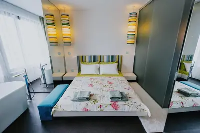 a bedroom with a large bed with flowers on it at Miletia Suites in Sozopol