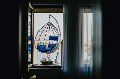 a window with a hammock in a cage at Miletia Suites in Sozopol