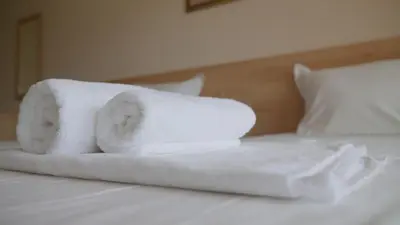 a pile of towels sitting on top of a bed at St. Sofia Beach Hotel in Kiten