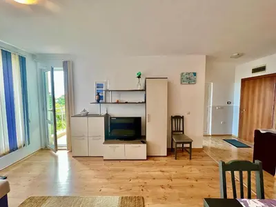 a living room with a television and a refrigerator at SOLITA Apartment with Panoramic View in Byala