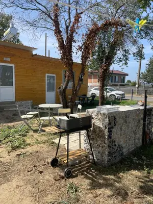 a grill in a yard next to a building at Sun Houses Novo Oriahovo in Novo Oryakhovo