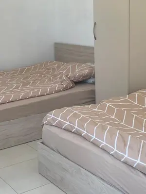 two beds sitting next to each other in a room at Sun Houses Novo Oriahovo in Novo Oryakhovo
