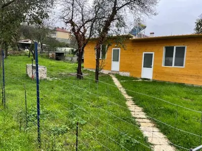 a fence in front of a house in a yard at Sun Houses Novo Oriahovo in Novo Oryakhovo