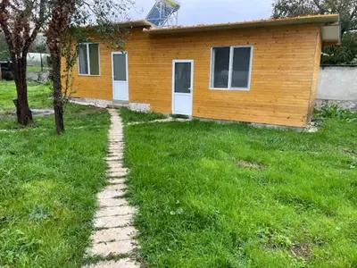 a brick path leading to a house in a yard at Sun Houses Novo Oriahovo in Novo Oryakhovo