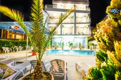a resort with a swimming pool and a building at Family Hotel Eliri in Nesebar
