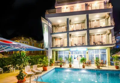 a hotel with a swimming pool in front of a building at Family Hotel Eliri in Nesebar