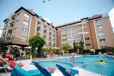 a hotel with a swimming pool with people sitting in chairs at K&E studios and apartments - All inclusive - Free parking in Sunny Beach