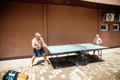 a man and a boy playing a table tennis at K&E studios and apartments - All inclusive - Free parking in Sunny Beach