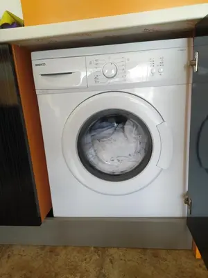 a white washing machine sitting in a room at Mellia Boutique Apartments in Ravda