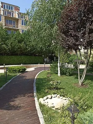 a walkway in a park next to a building at Mellia Boutique Apartments in Ravda