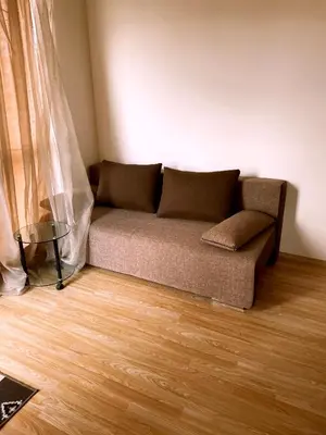 a couch in a living room with a wooden floor at Mellia Boutique Apartments in Ravda