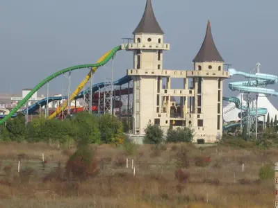 an amusement park with a roller coaster and a ride at Mellia Boutique Apartments in Ravda