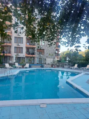a large swimming pool in front of a building at Апартамент Бриз 16 in Sunny Beach