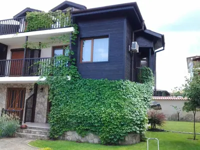 a house with ivy growing up the side of it at Paradise Bay Villas in Sozopol