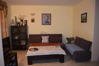 a living room with a couch and a table at Paradise Bay Villas in Sozopol