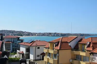 a group of houses with the water in the background at Paradise Bay Villas in Sozopol