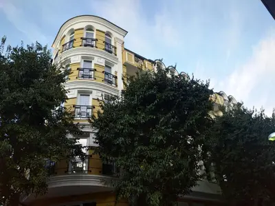a yellow and white building with balconies on it at апартамент Релакс in Varna City