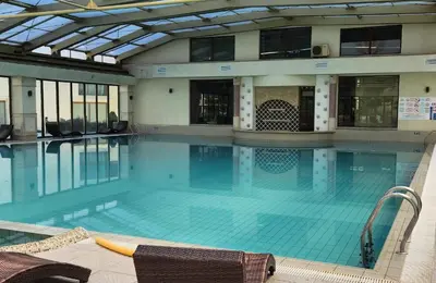 a large swimming pool in a building at Golden Sunrise in Shkorpilovtsi