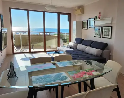 a living room with a glass table and a couch at Golden Sunrise in Shkorpilovtsi