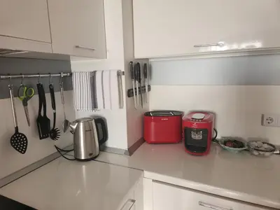 a kitchen with a red appliance on a counter at Golden Sunrise in Shkorpilovtsi