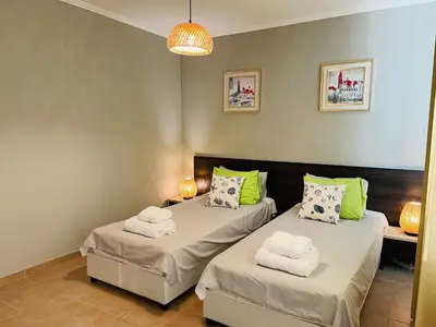 a bedroom with two beds with towels on them at Комплекс Бриз / Breeze Complex Apartments in Sunny Beach