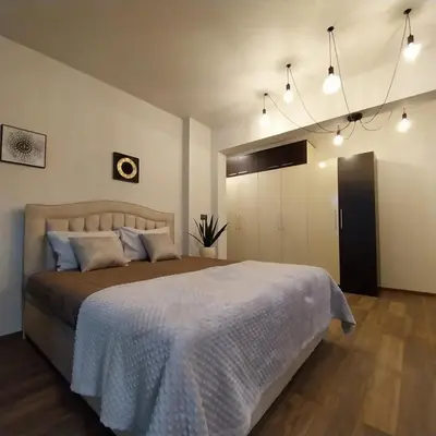 a bedroom with a large bed in a room at Ika studio in Burgas City
