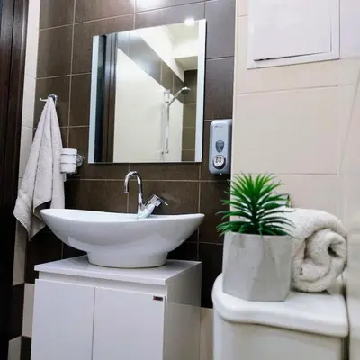 a bathroom with a sink and a plant on a toilet at Ika studio in Burgas City