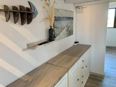 a kitchen with a counter with a vase on the wall at Seaview Holiday - Черноморска почивка in Aheloy