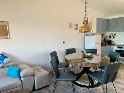 a living room with a table and a couch at Seaview Holiday - Черноморска почивка in Aheloy