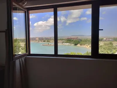 a window with a view of a body of water at Seaview Holiday - Черноморска почивка in Aheloy