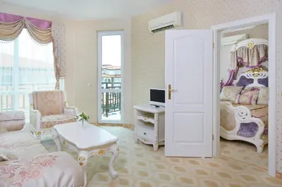 a room with a bedroom with a bed and a desk at Hotel Amore Beach - All Inclusive in Elenite