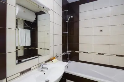 a bathroom with a sink and a mirror at Hotel Amore Beach - All Inclusive in Elenite