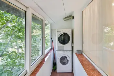 a washing machine in a laundry room with windows at Hideout in heart of Varna with WiFi in Varna City