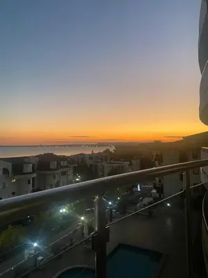 a view of the sunset from the balcony of a building at Lazur Sea View, Sveti Vlas Beach in Sveti Vlas