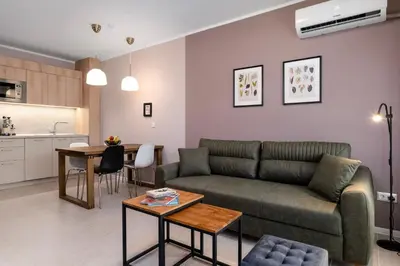 a living room with a couch and a table at Smokinia Sunrise - Kavatsi Beach, Sozopol in Sozopol