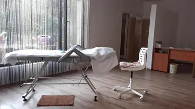 a hospital table and a chair in a room at Hotel Gamartata in Duni