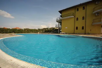 a large swimming pool in front of a building at Menada Green Hills Apartments in Sozopol