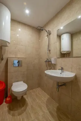 a bathroom with a toilet and a sink at Elmona Villas in Kamchia
