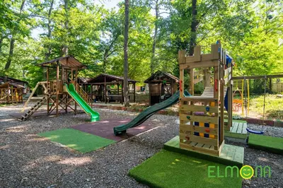 a playground with two slides and a swing set at Elmona Villas in Kamchia