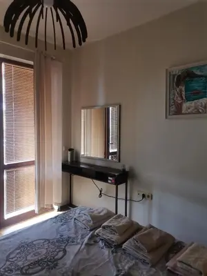 a bedroom with a bed with a mirror and a desk at Апартамент в Oasis beach Kamchia - Лунна пътека in Dolen Bliznak