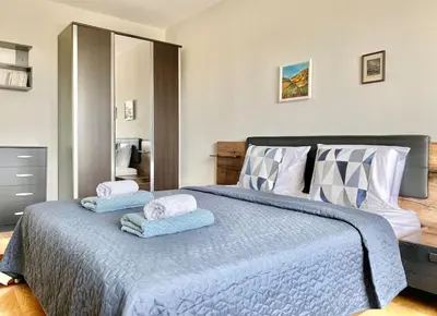 a bedroom with a bed with two towels on it at Alonia - your Burgas shelter by the park and beach in Burgas City