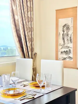 a table with two chairs and a table with wine glasses at Alonia - your Burgas shelter by the park and beach in Burgas City