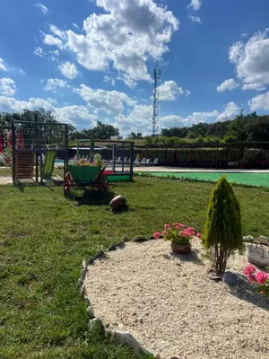 a park with a playground and a bench and flowers at Комплекс Тополица -The beautiful view in Aytos