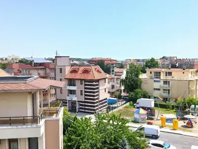a view of a city with buildings and cars at Голям апартамент с прекрасна гледка кьм морето in Ravda