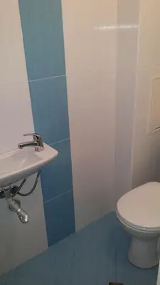 a bathroom with a toilet and a sink at Guest House Margarita in Pomorie