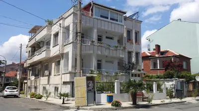 a white building on the side of a street at Guest House Margarita in Pomorie