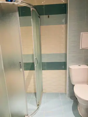a shower in a bathroom with a toilet at Admiral Plaza in Sunny Beach