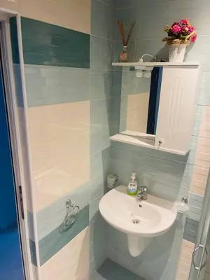 a bathroom with a sink and a mirror at Admiral Plaza in Sunny Beach