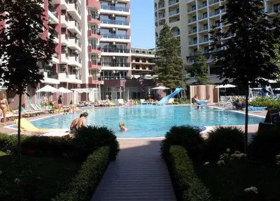 a large swimming pool with people in a resort at Admiral Plaza in Sunny Beach