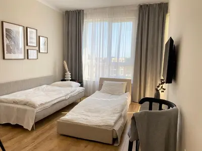 a hotel room with two beds and a window at Ravda Bliss with a pool in Ravda
